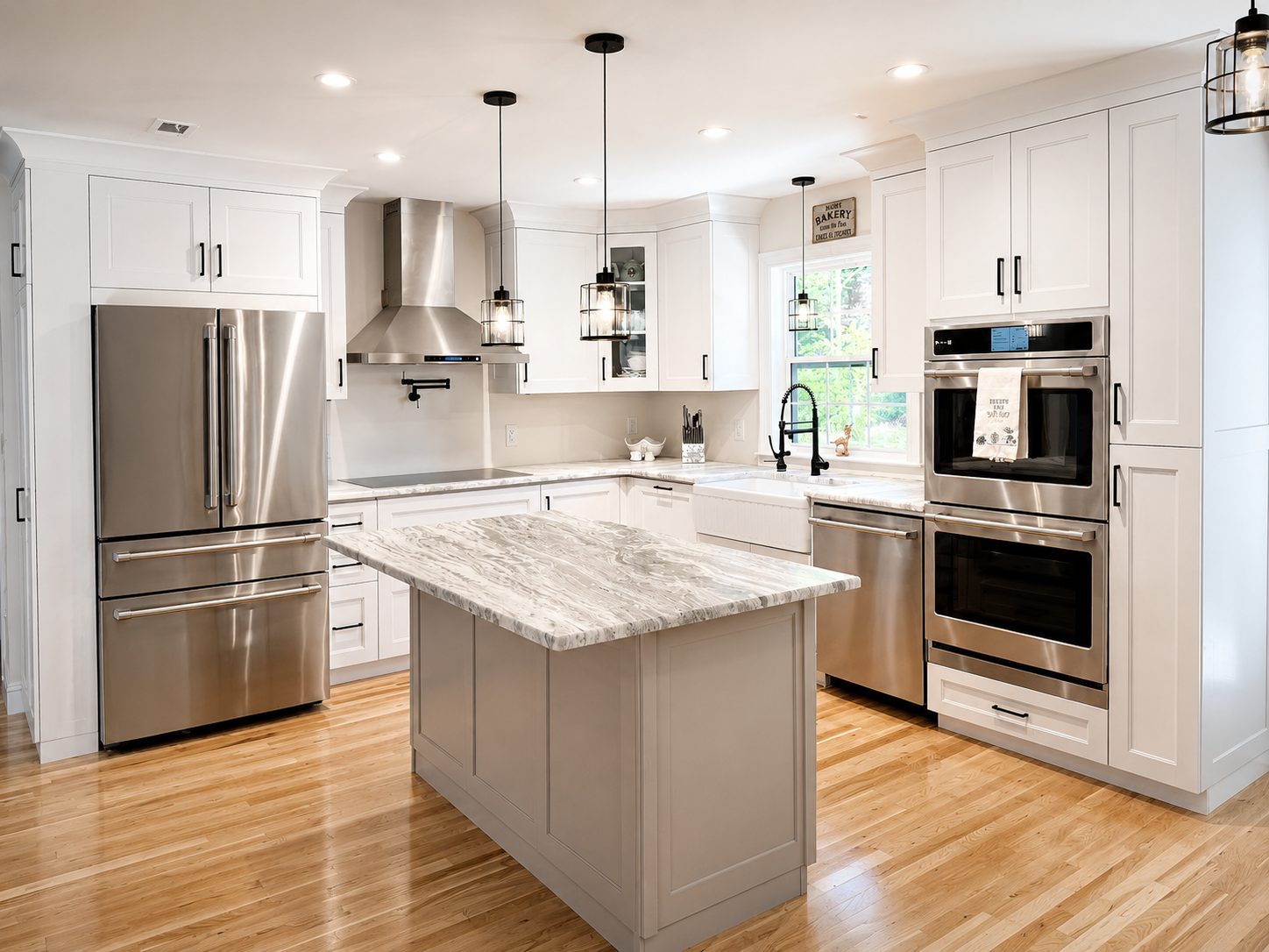 White shaker kitchen with marble waterfall island